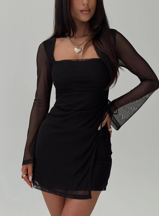 Model wearing a black mesh sleeve mini dress from the front