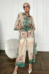 woman wearing a floral print two-piece set with a button-down shirt and wide-leg pants