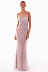 A woman models a sparkling lavender floor-length gown with a cowl neckline and spaghetti straps, front view.