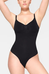 Woman wearing a black seamless shaping bodysuit from the front
