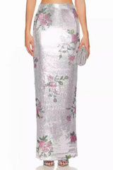 Close-up of the floral print and sequin detail on the silver maxi skirt.