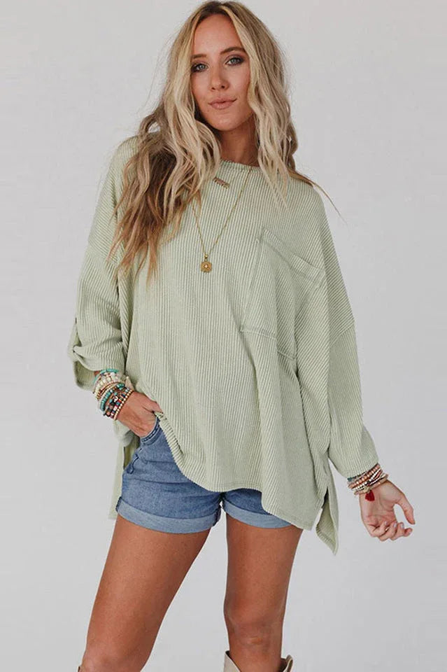 Close-up of a woman in a light green ribbed top and denim shorts, showcasing the texture and pocket.