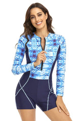 Woman wearing a blue tie-dye long-sleeve one-piece swimsuit with shorts