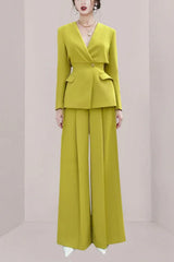 Woman wearing a lime green pantsuit with wide-leg pants and a lapel blazer.