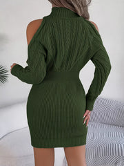 back view of a woman wearing a green knitted cold shoulder mock neck dress