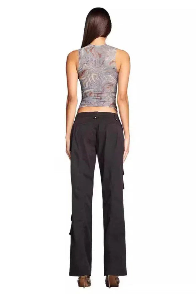 Back view of a woman wearing a marble print mesh tank top and black cargo pants