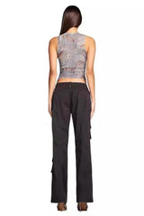 Back view of a woman wearing a marble print mesh tank top and black cargo pants