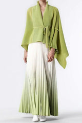Model wearing a lime green wrap top and white to lime green ombre pleated maxi skirt.