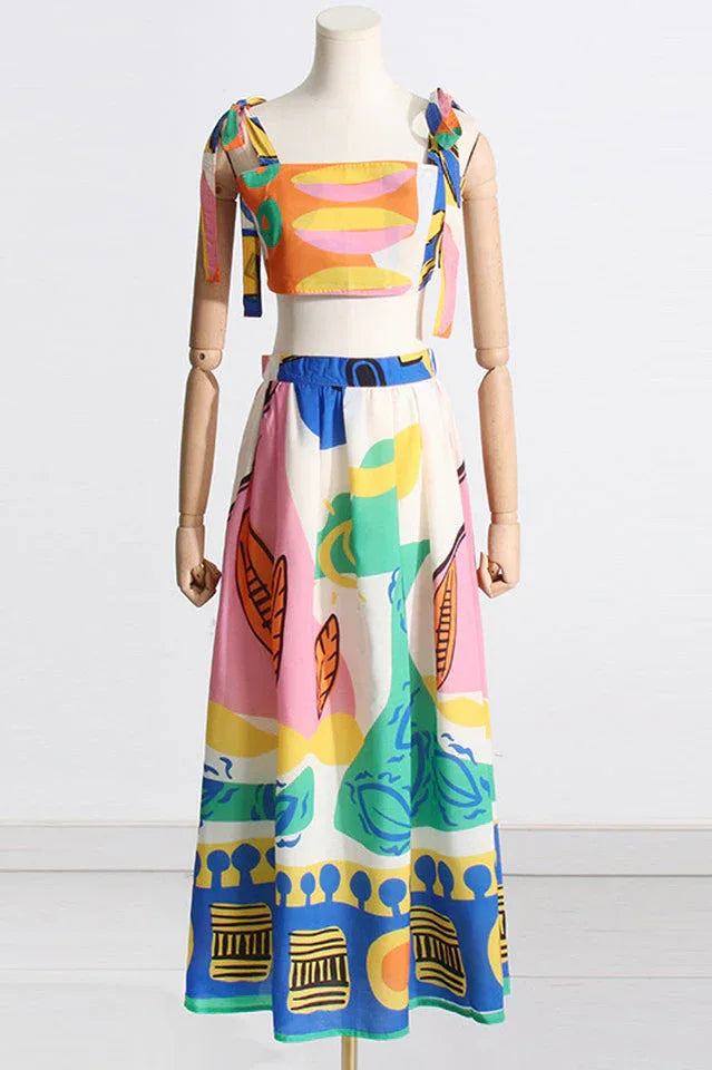 Mannequin displaying a sleeveless crop top and maxi skirt set with an abstract pattern
