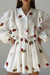 Close-up of the white strawberry print blouse and skirt, highlighting the fabric texture and embroidery details.