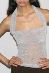 Front view of a silver sparkly halter top, showing the square neckline and sheer midriff.