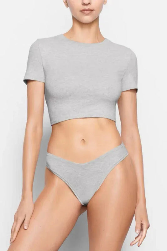 Model wearing a light grey cropped t-shirt and matching underwear