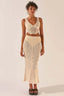 Woman wearing a cream crochet knit crop top and matching maxi skirt, front view.