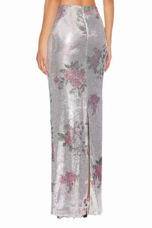 Back view of the silver sequined maxi skirt with a floral print, showing the slit.