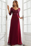Woman wearing a floor-length burgundy sequined formal gown with 3/4 sleeves, standing in a doorway.