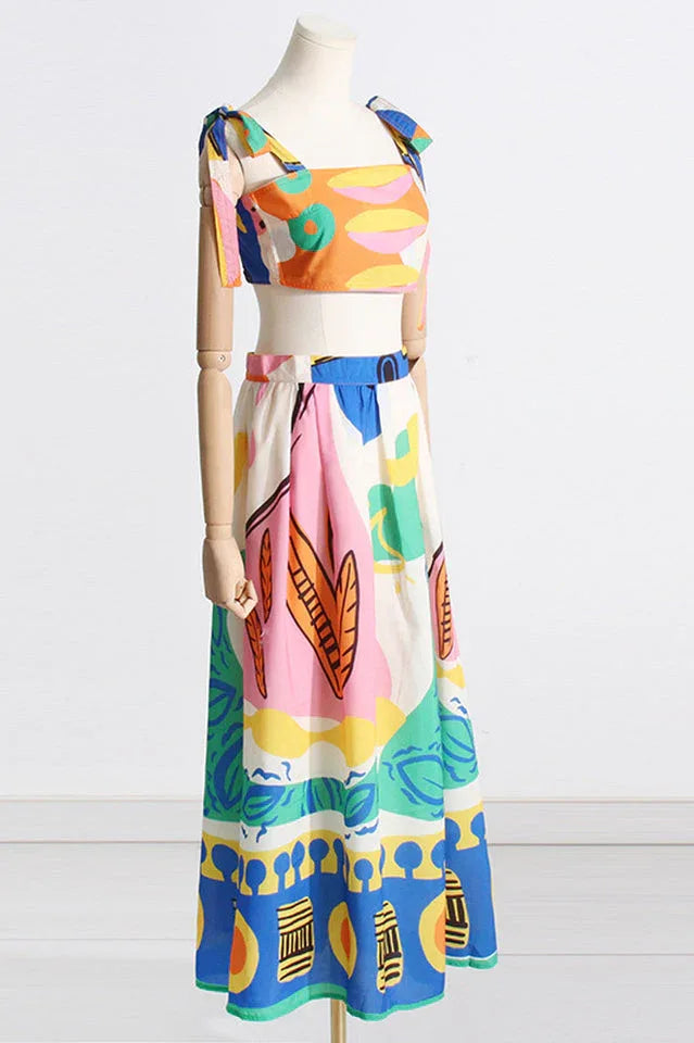 Side view of a mannequin showcasing a colorful abstract print crop top and maxi skirt ensemble