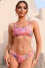 Woman wearing a pink floral print bikini set