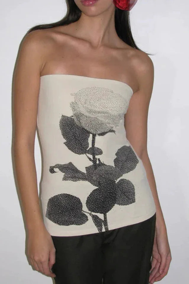 Close-up of a cream strapless tube top with a black rose graphic print.
