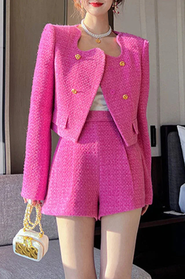Full body shot of a woman in a pink tweed co-ord set