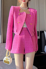 Full body shot of a woman in a pink tweed co-ord set