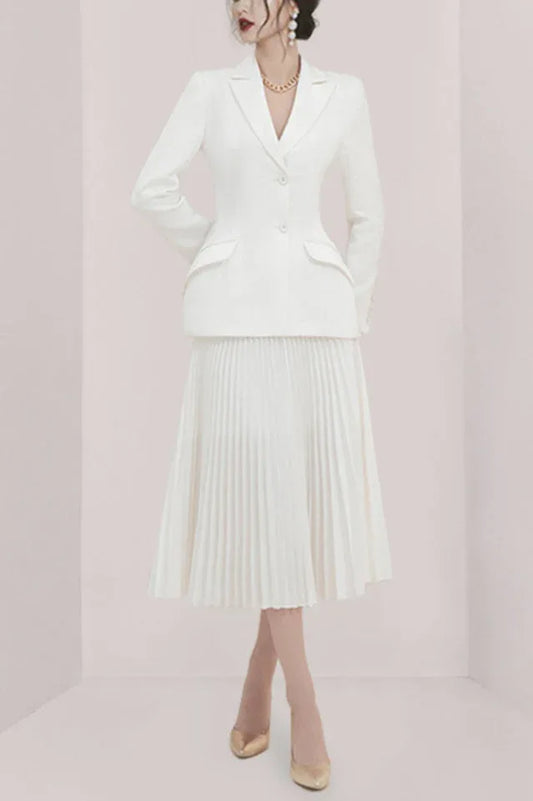 Woman wearing a white pleated skirt suit from the front
