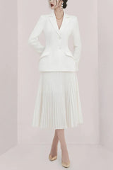 Woman wearing a white pleated skirt suit from the front