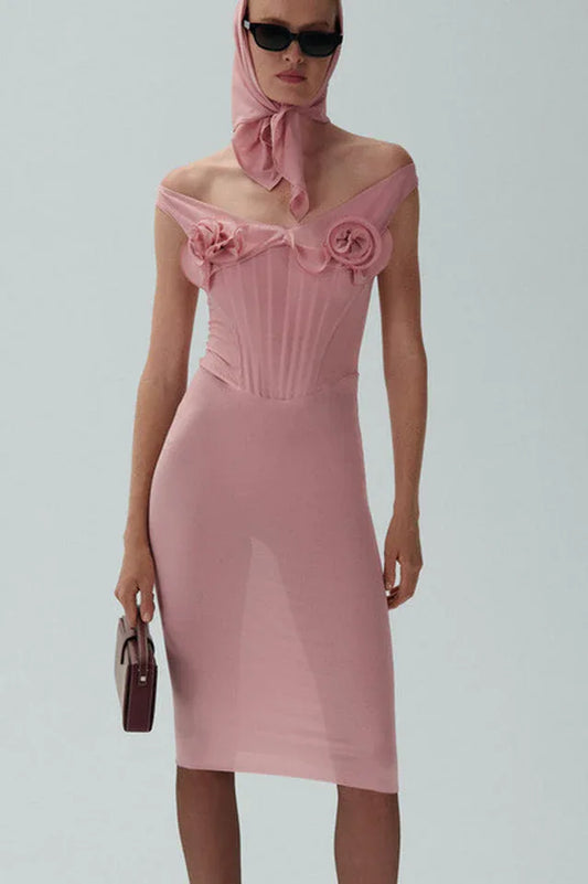 Model wearing a pink off-the-shoulder mesh sheath dress with floral appliqués and a matching headscarf.