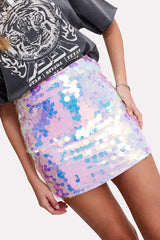 Close-up of a woman wearing a pastel iridescent sequin mini skirt.