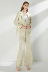 Full body shot of a woman in a cream jacquard suit.
