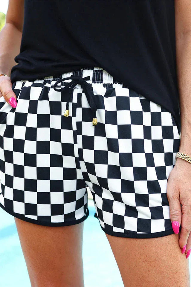 Close-up of black and white checkerboard shorts with drawstring