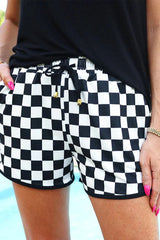 Close-up of black and white checkerboard shorts with drawstring