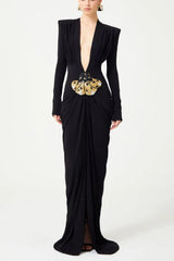 Black long-sleeved gown with a plunging V-neckline and a draped skirt, featuring a jeweled butterfly embellishment at the waist.