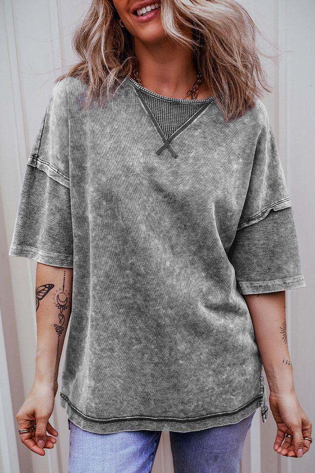 Woman wearing a grey acid wash oversized t-shirt from the front