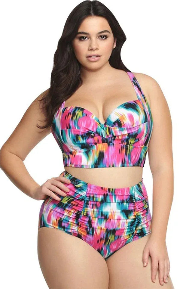 Plus-size model wearing a colorful abstract print high-waisted bikini