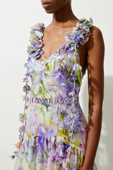 Detail of the floral embellishments and ruffles on the straps of a midi dress.