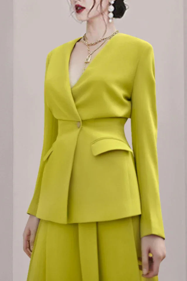 Close-up of a woman wearing a lime green lapel blazer with a V-neck.