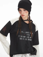 Close-up of the graphic print on the layered shirt, showing the text and star details.