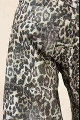 Close-up of the back pocket detail of wide leg leopard print denim pants.