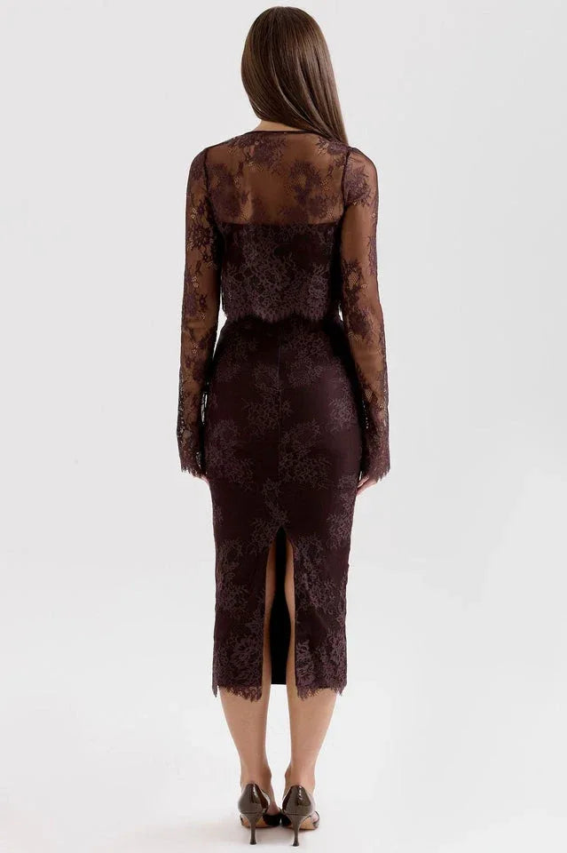 Back view of a woman in a dark brown lace midi dress with a slit and a matching lace bolero