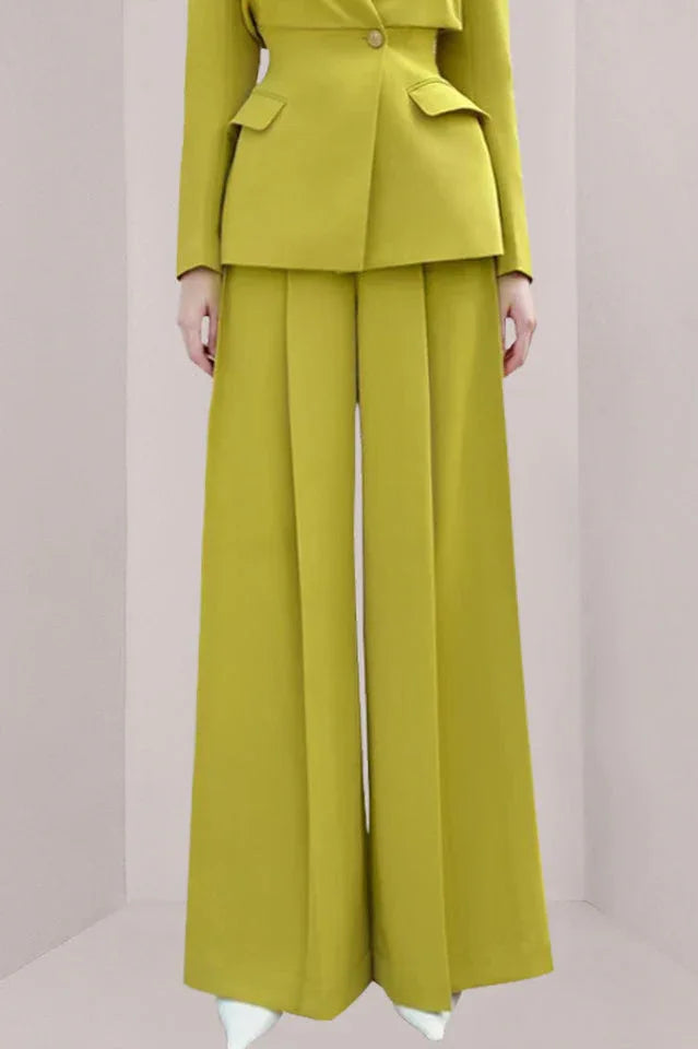 Close-up of a woman wearing lime green wide-leg pants with pleats.