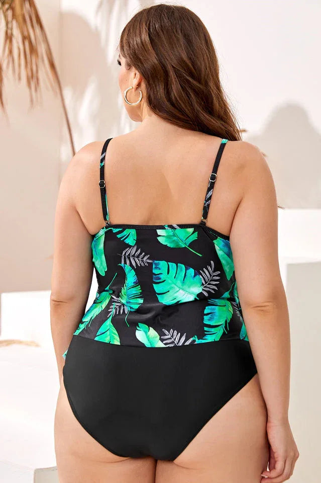 Back view of a plus-size model in a black and green leaf print tankini