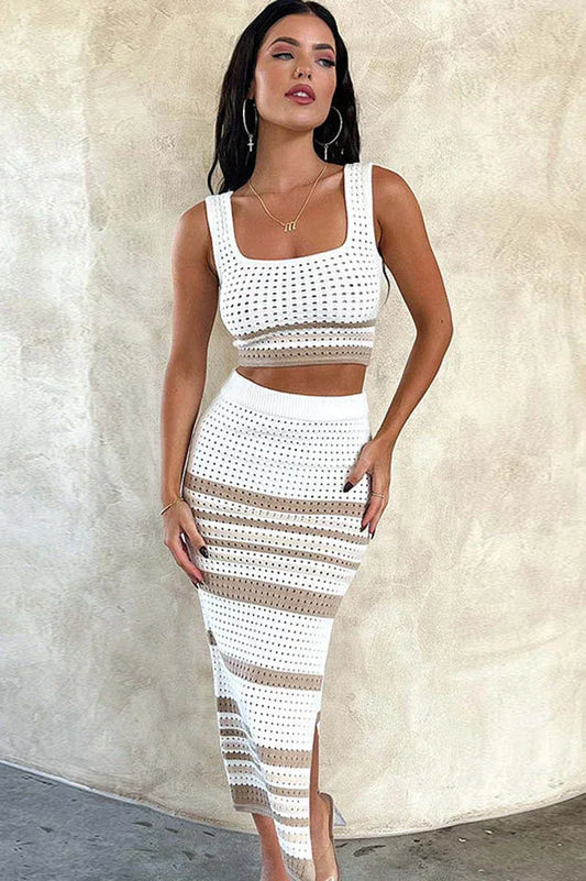 Woman wearing a white and tan striped knit cropped tank top and matching midi skirt with a side slit, front view