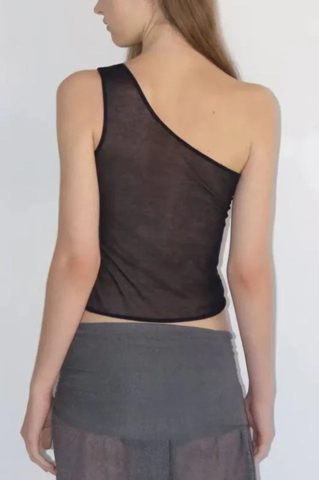 Back view of a woman wearing a black asymmetrical sheer knit top.