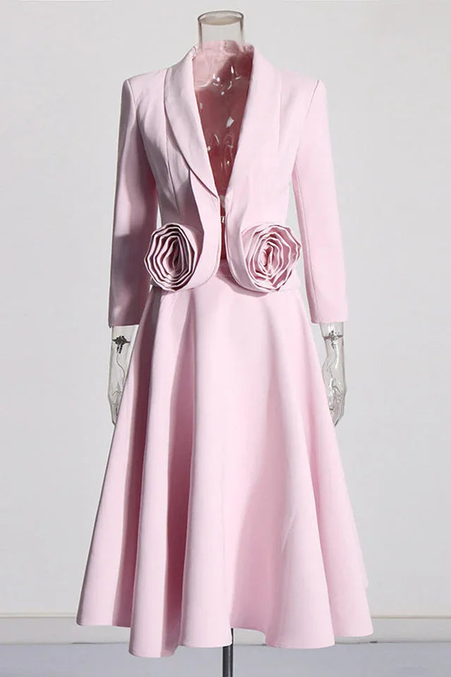 Pink blazer and skirt set with rose embellishments displayed on a mannequin