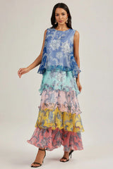 A woman poses in a vibrant, layered chiffon dress with a paisley-inspired floral pattern.