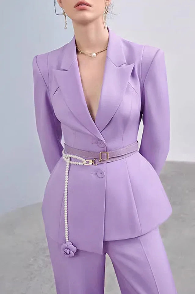 Close-up of a woman's torso wearing a lavender peplum suit with a pearl belt