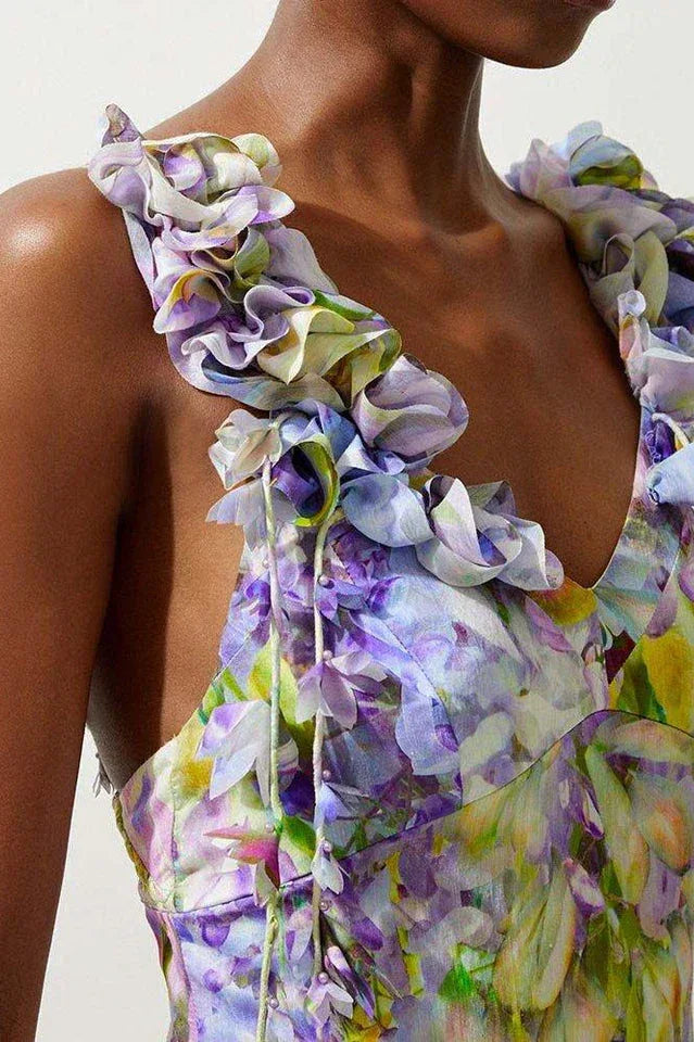 Close-up of the ruffled shoulder detail on a floral print midi dress.