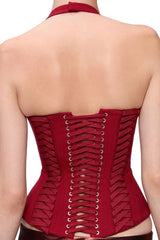 Back view of a red halter corset top with a lace-up closure and side ribbon detailing.