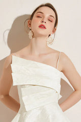 Back view of a woman in a white asymmetrical neckline dress, showing the zipper closure.