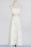 Mannequin wearing a white floral applique cropped top and A-line skirt
